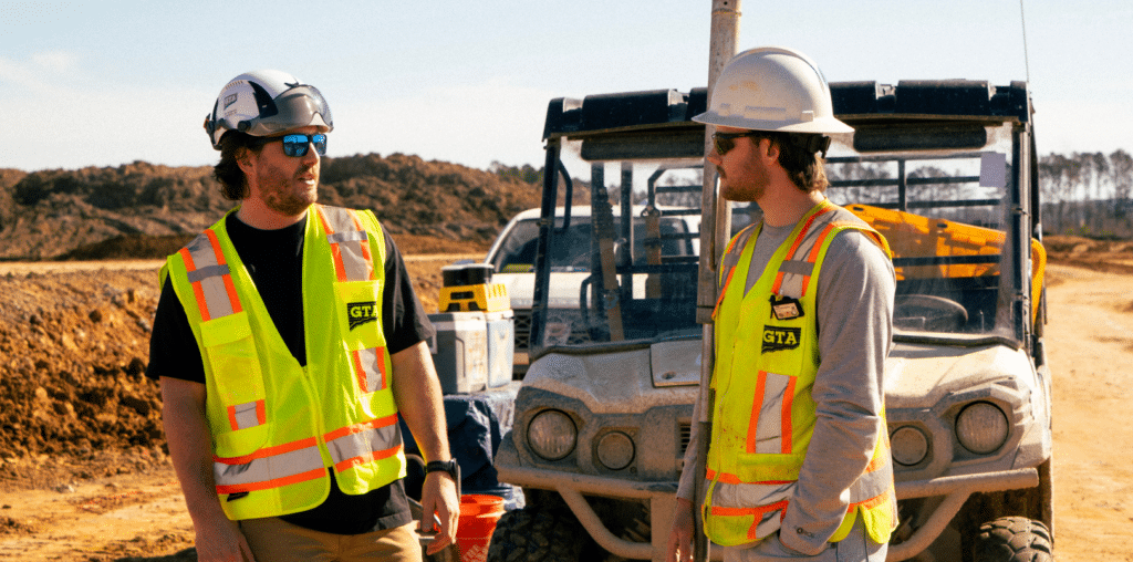image 1 - Geo-Technology Associates, Inc. Two gta employees talking to one another on a construction site