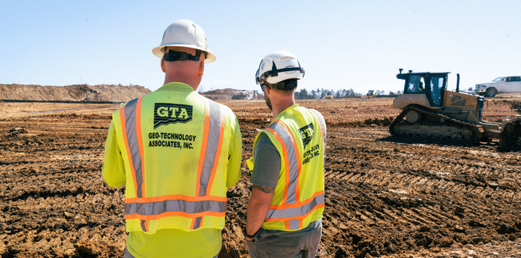 image 2 - Geo-Technology Associates, Inc. Two gta employees overlooking a project site